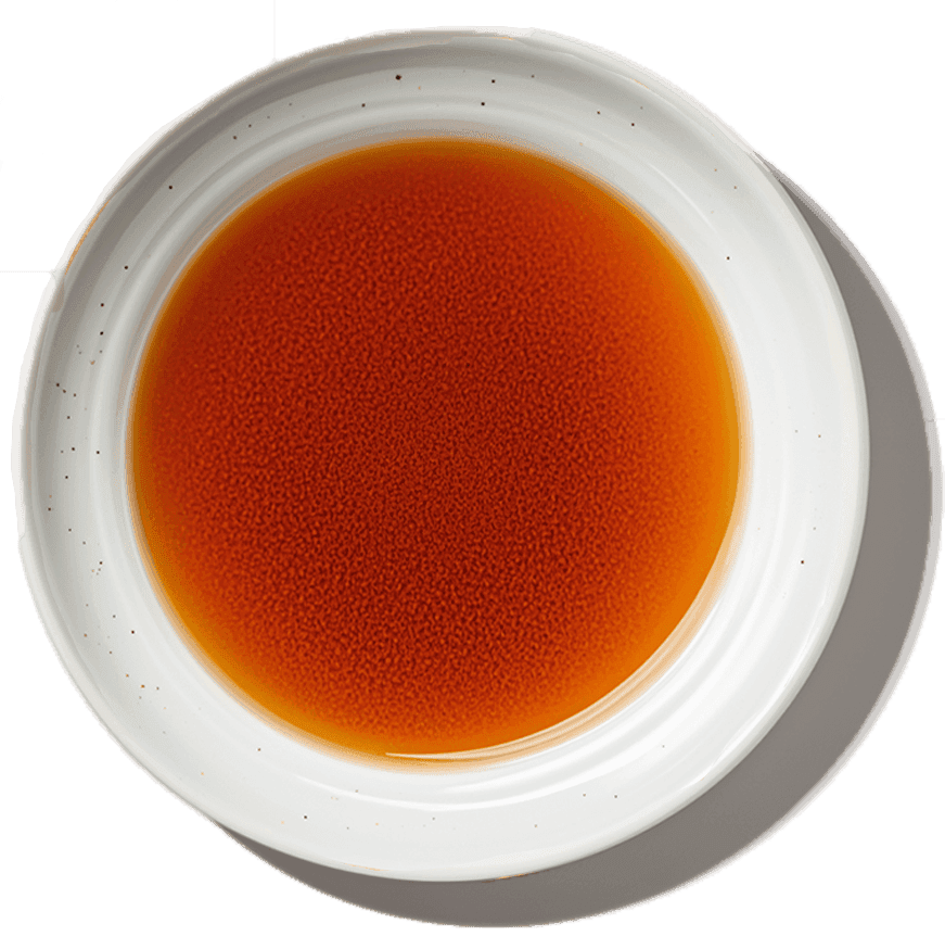 A brewed herbal decoction in a white bowl